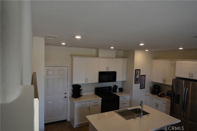 975 W Clover Ave, Rialto, CA 92376 - kitchen featuring black appliances, a kitchen island with sink, light countertops, white cabinets, and recessed lighting