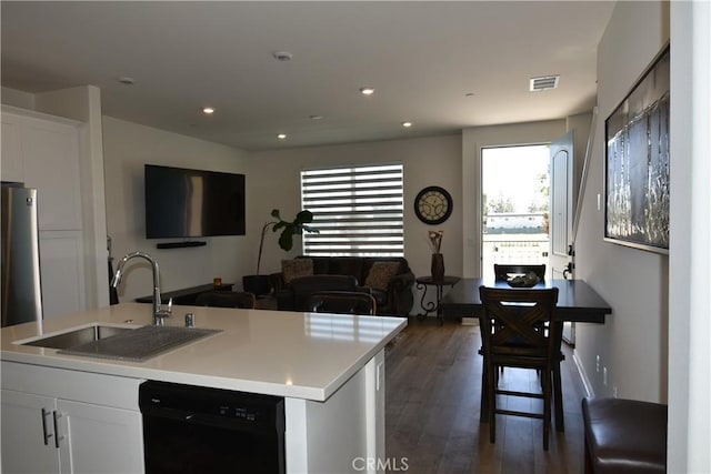 975 W Clover Ave, Rialto, CA 92376 - kitchen featuring dishwasher, dark wood-type flooring, white cabinetry, light countertops, and open floor plan