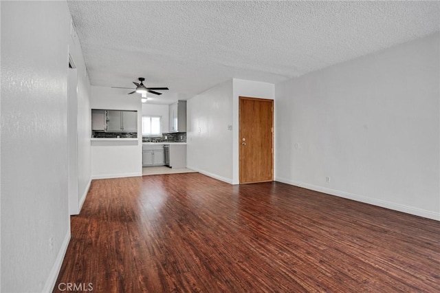 218 E Tamarack Ave Unit 5, Inglewood, CA 90301 - unfurnished living room with dark wood finished floors, ceiling fan, and a textured ceiling