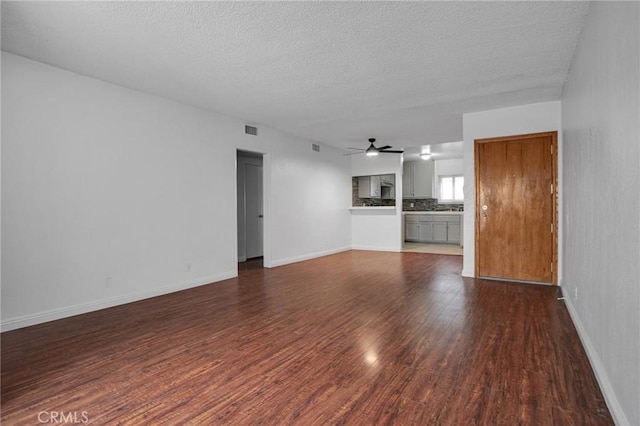 218 E Tamarack Ave Unit 5, Inglewood, CA 90301 - unfurnished living room with dark wood-style flooring, ceiling fan, and a textured ceiling