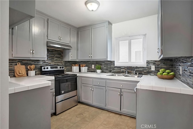 218 E Tamarack Ave Unit 5, Inglewood, CA 90301 - kitchen featuring stainless steel electric range, under cabinet range hood, tile countertops, and backsplash