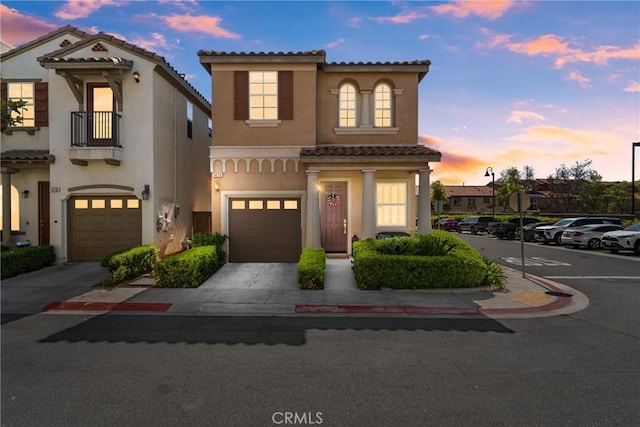 1474 De La Vina St, Chula Vista, CA 91913 - view of front facade featuring a tiled roof, a balcony, stucco siding, a garage, and driveway