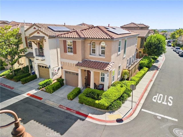 1474 De La Vina St, Chula Vista, CA 91913 - view of front of home featuring a garage, stucco siding, roof mounted solar panels, a tiled roof, and concrete driveway