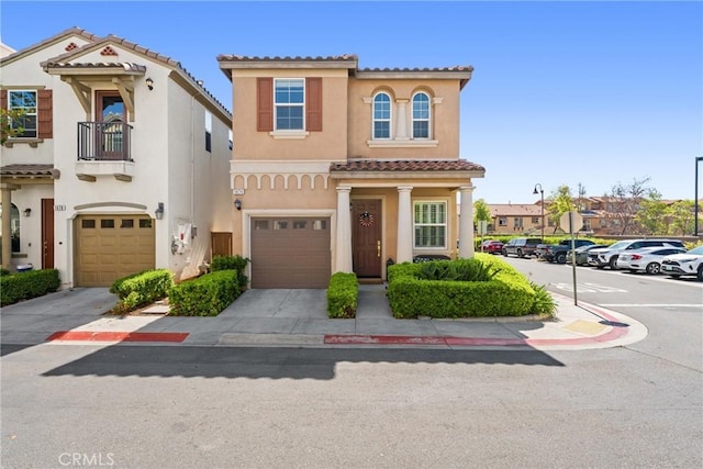1474 De La Vina St, Chula Vista, CA 91913 - view of front of home featuring a tiled roof, stucco siding, a garage, and a balcony