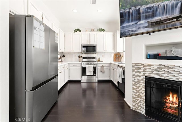 1474 De La Vina St, Chula Vista, CA 91913 - kitchen with appliances with stainless steel finishes, light countertops, white cabinets, decorative backsplash, and recessed lighting