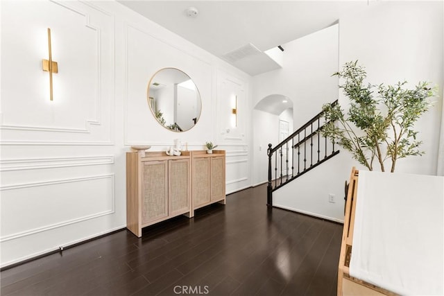 1474 De La Vina St, Chula Vista, CA 91913 - entrance foyer featuring arched walkways, dark wood-type flooring, and stairway
