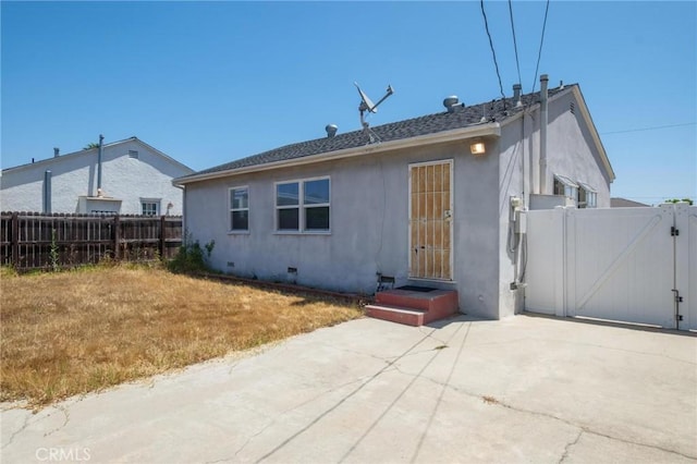 15511 Gramercy Pl, Gardena, CA 90249 - back of house featuring stucco siding, a gate, and a patio area