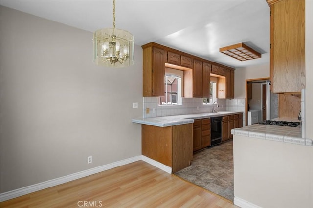 15511 Gramercy Pl, Gardena, CA 90249 - kitchen with tile countertops, dishwasher, decorative backsplash, a chandelier, and light wood finished floors