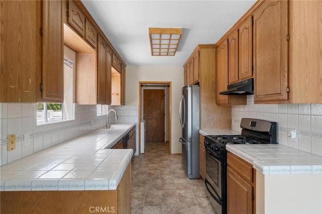 15511 Gramercy Pl, Gardena, CA 90249 - kitchen featuring gas stove, freestanding refrigerator, under cabinet range hood, tile countertops, and decorative backsplash
