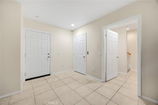 1565 Ledgestone Ln, Pomona, CA 91767 - foyer with light tile patterned floors, recessed lighting, and stairway