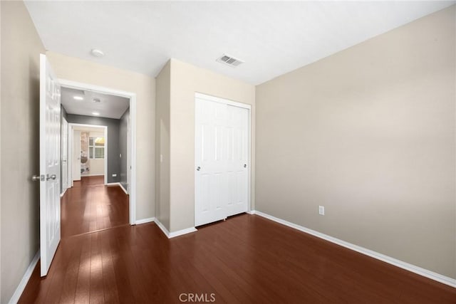 1565 Ledgestone Ln, Pomona, CA 91767 - unfurnished bedroom featuring dark wood finished floors and a closet
