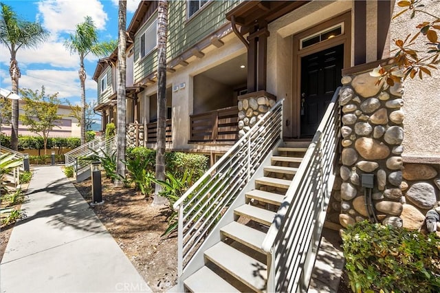 1565 Ledgestone Ln, Pomona, CA 91767 - property entrance with mansard roof and stucco siding