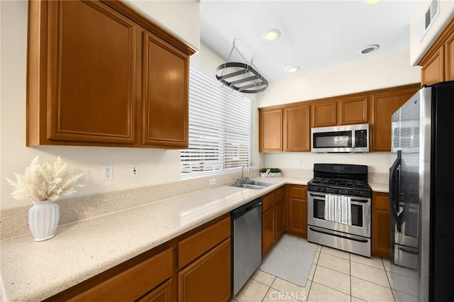 1565 Ledgestone Ln, Pomona, CA 91767 - kitchen featuring appliances with stainless steel finishes, light tile patterned flooring, and brown cabinets
