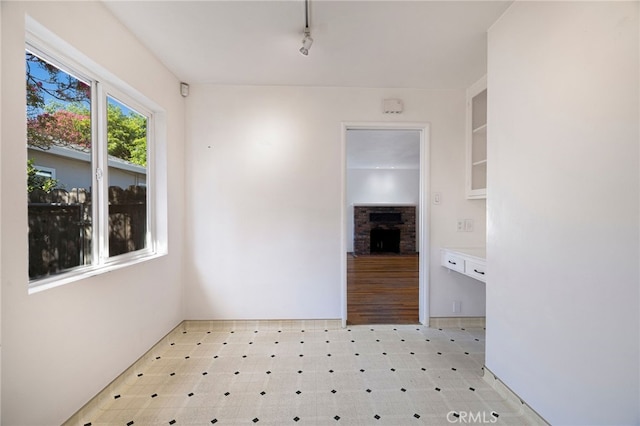 1245 Palm Ave, Chico, CA 95926 - spare room with a fireplace, light flooring, and track lighting