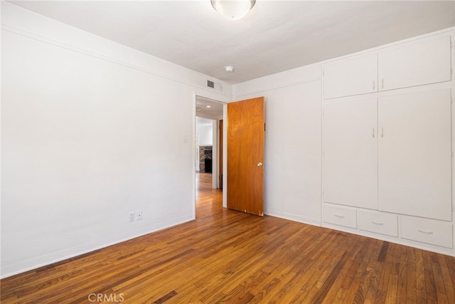 1245 Palm Ave, Chico, CA 95926 - unfurnished bedroom with wood finished floors and a closet