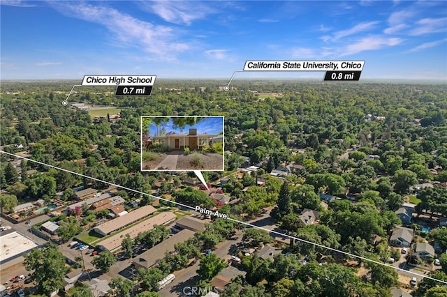 1245 Palm Ave, Chico, CA 95926 - aerial view of property and surrounding area featuring property parcel outlined and a heavily wooded area