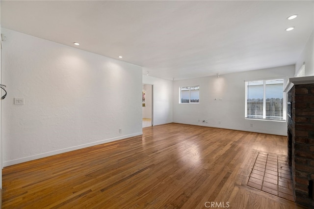 1245 Palm Ave, Chico, CA 95926 - unfurnished living room featuring wood finished floors, a fireplace, and recessed lighting
