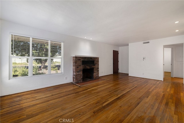 1245 Palm Ave, Chico, CA 95926 - unfurnished living room with wood finished floors, recessed lighting, and a brick fireplace