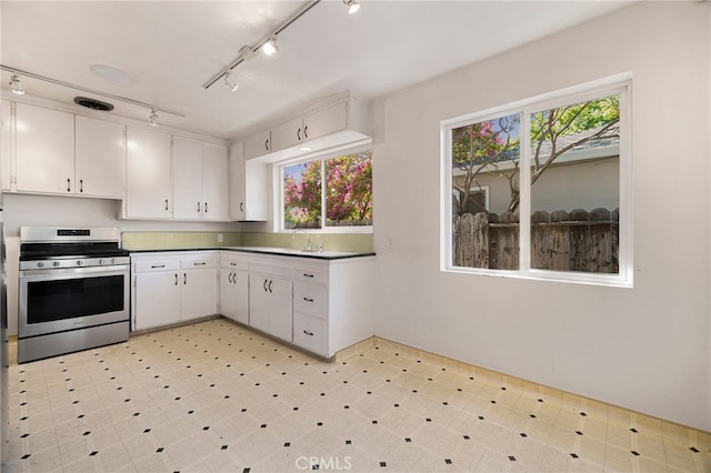 1245 Palm Ave, Chico, CA 95926 - kitchen featuring stainless steel range, track lighting, light floors, white cabinetry, and dark countertops