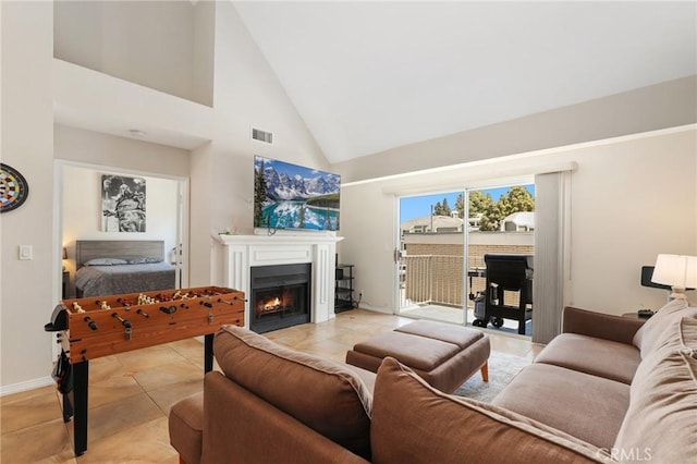 810 Baker St Unit 210, Costa Mesa, CA 92626 - living room with a warm lit fireplace, high vaulted ceiling, and light tile patterned flooring