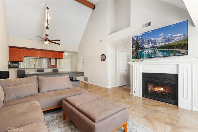 810 Baker St Unit 210, Costa Mesa, CA 92626 - living area featuring high vaulted ceiling, ceiling fan, a warm lit fireplace, and tile patterned flooring