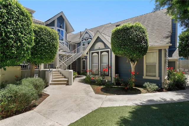 810 Baker St Unit 210, Costa Mesa, CA 92626 - view of front facade featuring stairs and a shingled roof