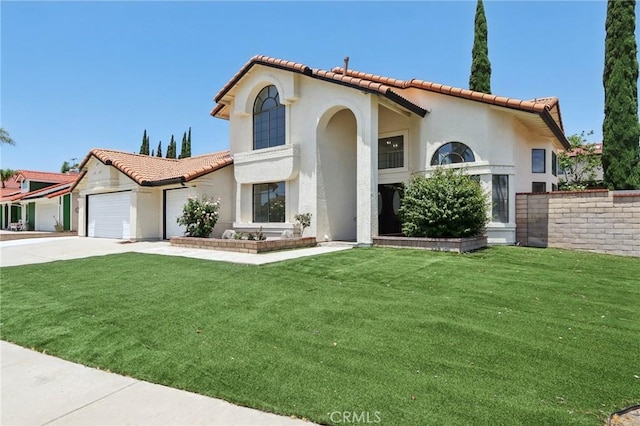 1122 W Galway St, Rialto, CA 92377 - mediterranean / spanish-style house featuring a tile roof, driveway, a garage, and stucco siding