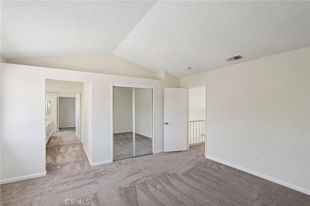 1122 W Galway St, Rialto, CA 92377 - unfurnished bedroom featuring lofted ceiling, carpet floors, a textured ceiling, and a closet