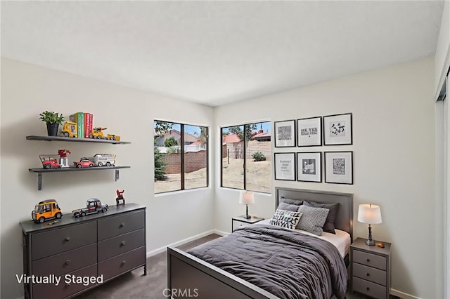 1122 W Galway St, Rialto, CA 92377 - bedroom with baseboards and dark carpet