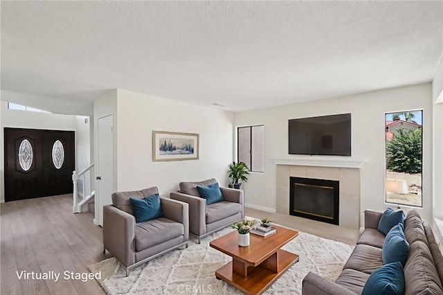 1122 W Galway St, Rialto, CA 92377 - living room with wood finished floors and a tile fireplace