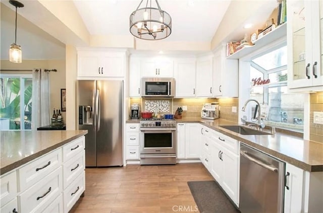 25491 2nd St, Lake Forest, CA 92630 - kitchen featuring appliances with stainless steel finishes, lofted ceiling, plenty of natural light, and tasteful backsplash
