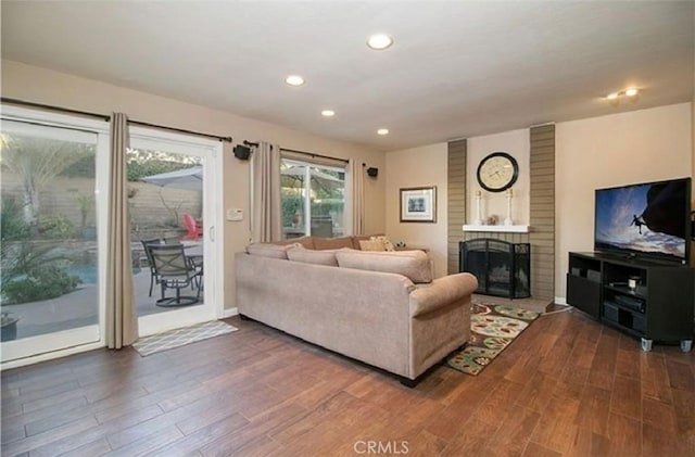 25491 2nd St, Lake Forest, CA 92630 - living area with dark wood-style floors, a brick fireplace, and recessed lighting
