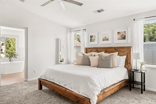 3192 Sawyers Bar Ln, Chico, CA 95973 - carpeted bedroom with multiple windows, a ceiling fan, and connected bathroom
