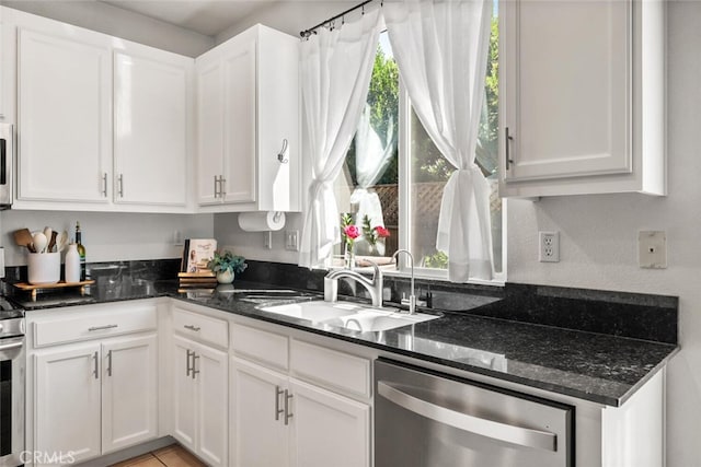3192 Sawyers Bar Ln, Chico, CA 95973 - kitchen featuring stainless steel dishwasher, white cabinetry, and dark stone counters