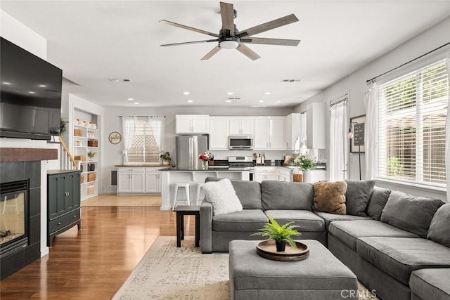 3192 Sawyers Bar Ln, Chico, CA 95973 - living area with a ceiling fan, light wood-style floors, a tile fireplace, and recessed lighting