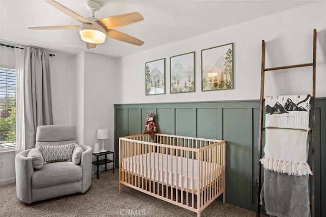 3192 Sawyers Bar Ln, Chico, CA 95973 - bedroom featuring a crib, carpet floors, a decorative wall, a ceiling fan, and a wainscoted wall