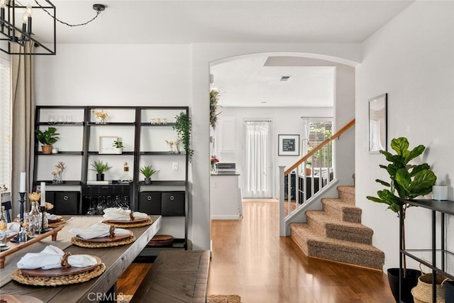 3192 Sawyers Bar Ln, Chico, CA 95973 - dining room with arched walkways, wood finished floors, and stairway