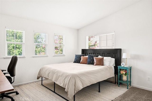 3192 Sawyers Bar Ln, Chico, CA 95973 - bedroom featuring multiple windows, vaulted ceiling, light colored carpet, and a desk