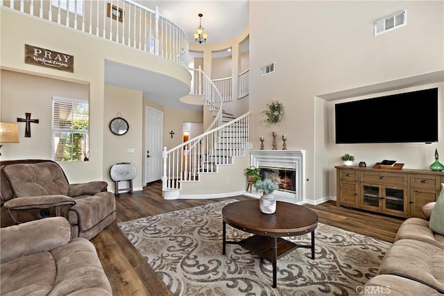 31956 Via Del Paso, Winchester, CA 92596 - living room with a towering ceiling, stairs, wood finished floors, and a chandelier