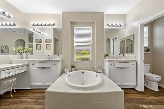 31956 Via Del Paso, Winchester, CA 92596 - bathroom featuring two vanities, a garden tub, and wood finished floors