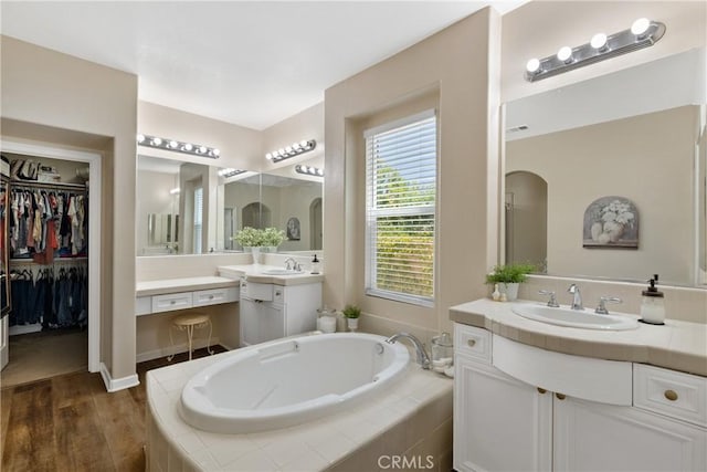 31956 Via Del Paso, Winchester, CA 92596 - bathroom with a garden tub, two vanities, wood finished floors, and a walk in closet