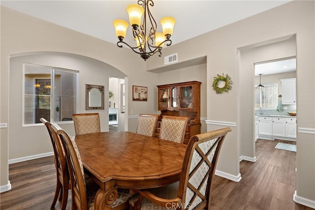 31956 Via Del Paso, Winchester, CA 92596 - dining space with arched walkways, dark wood-type flooring, and a chandelier