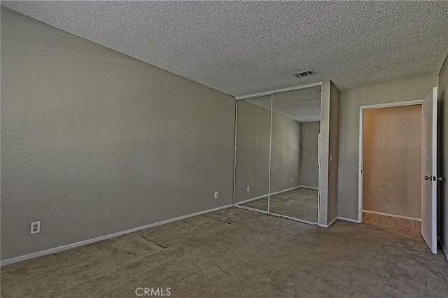 1209 Edwards St Unit 56, Redlands, CA 92374 - unfurnished bedroom with carpet, a closet, and a textured ceiling