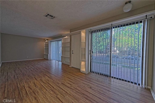 1209 Edwards St Unit 56, Redlands, CA 92374 - unfurnished room featuring a textured ceiling and wood finished floors