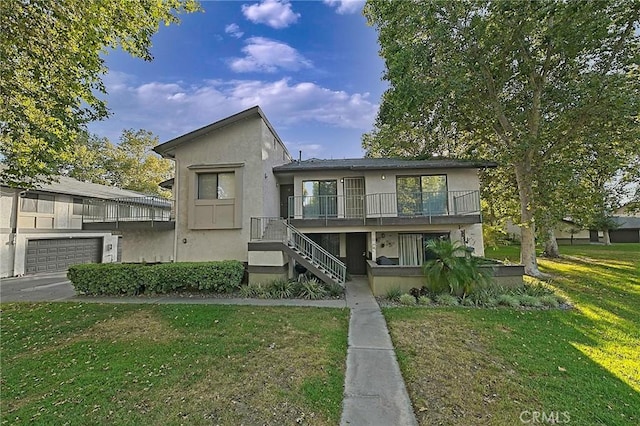 1209 Edwards St Unit 56, Redlands, CA 92374 - view of front of home featuring a front lawn, stucco siding, stairs, and a balcony