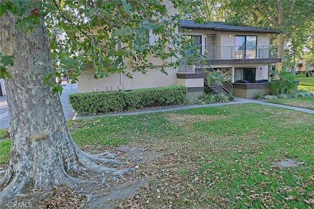 1209 Edwards St Unit 56, Redlands, CA 92374 - view of front of home with a front yard, stucco siding, and stairs