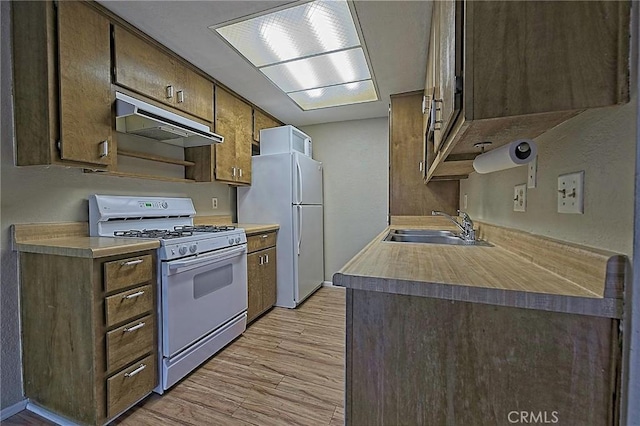 1209 Edwards St Unit 56, Redlands, CA 92374 - kitchen featuring white appliances, under cabinet range hood, light wood finished floors, and light countertops