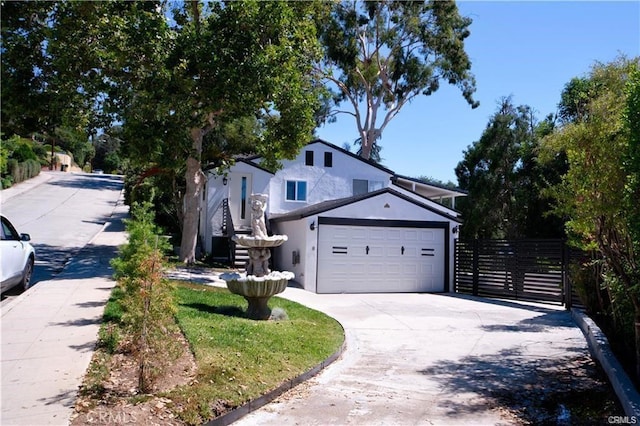 1020 Lantana Dr, Los Angeles, CA 90042 - view of front of house featuring stucco siding, an attached garage, and driveway