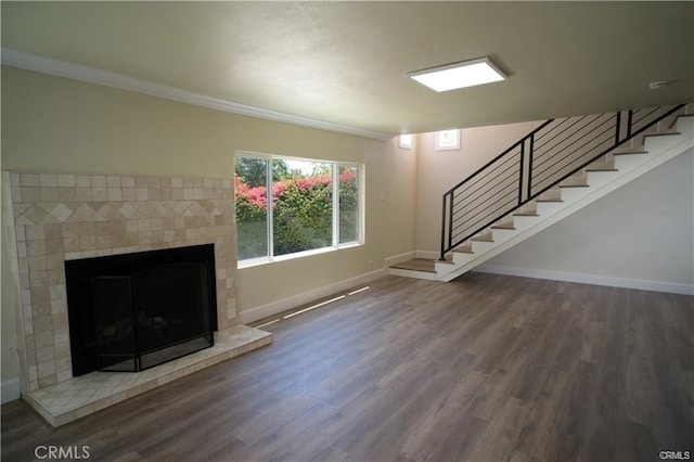 1020 Lantana Dr, Los Angeles, CA 90042 - unfurnished living room with wood finished floors, stairway, a brick fireplace, and ornamental molding