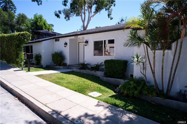 1020 Lantana Dr, Los Angeles, CA 90042 - view of front facade featuring stucco siding and a front lawn